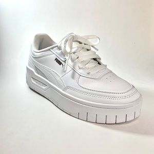 Woman’s white platform pumas
